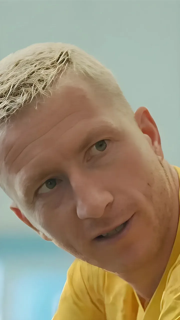 Marco Reus im BVB-Trikot — EA FC Mobile Nahaufnahme eines Spielers mit hellblond gefärbtem Haar im gelben Trikot, leicht zur Kamera geneigt