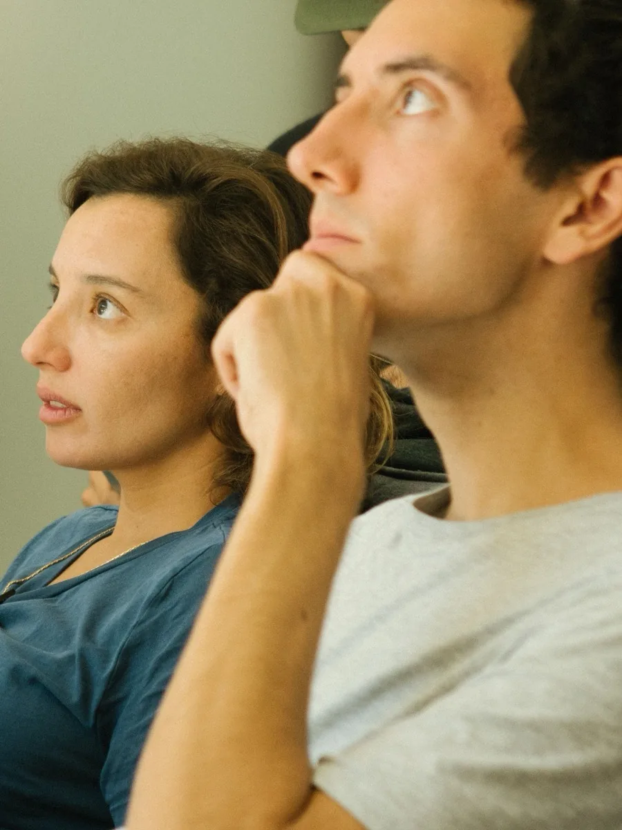 From a workshop for companies: a woman and a man sitting close together, both watching something intently; he rests his chin in his hand